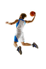 Back full-length image of male basketball player in motion, practicing, training isolated on white background. Concept of sport, competition, active and healthy lifestyle, game