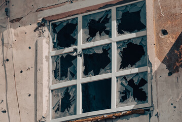 empty windows of a damaged house in Ukraine