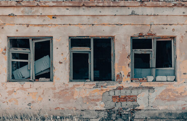 empty windows of a damaged house in Ukraine