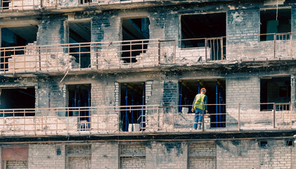 builder at work on the restoration and repair of destroyed houses in the city of Ukraine
