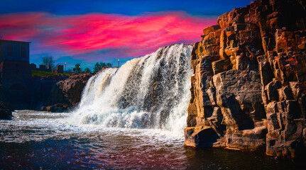 Sioux Falls City Spring Landscape at the Falls Park in Sioux Falls, South Dakota, USA, dramatic sunset cloudscape and water falling in the Big Sioux River
