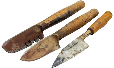 Three gardening tools with wooden handles resting on a neutral background, showcasing wear and tear from frequent use in outdoor planting and maintenance activities