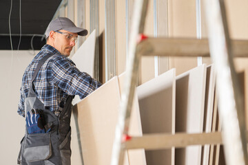 Construction Site Worker Selecting Right Drywall Panels