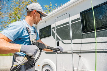 RV Rentals Worker Pressure Washing Class C Camper Van