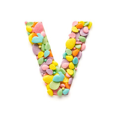 Capital letter is made of candies in the shape of Easter eggs on a white background.