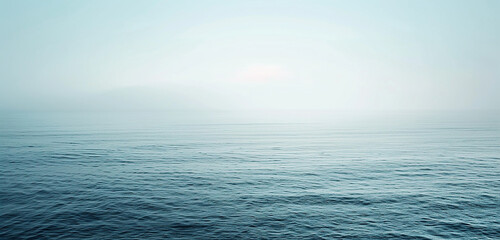 A panoramic view of a calm sea, the intensity of the ocean's blue gently faded near the horizon where it meets a pale, washed-out sky,32k, full ultra hd, high resolution - obrazy, fototapety, plakaty
