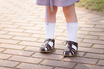 children's feet in sandals and white socks