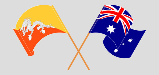 Crossed and waving flags of Bhutan and Australia