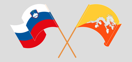Crossed and waving flags of Slovenia and Bhutan