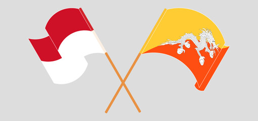 Crossed and waving flags of Indonesia and Bhutan