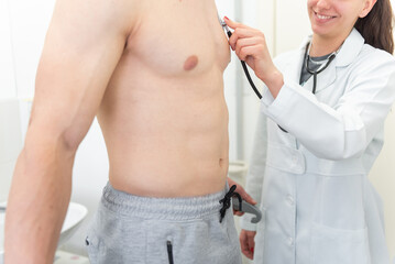 Diligent doctor conducting a thorough physical examination in clinical setting
