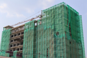 High-rise buildings under construction have coverings to prevent debris from spreading outside the...