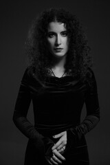 Black and white portrait of a beautiful passionate woman with curls.