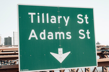 Obraz premium Tillary street, Adams street road sign on the side of the street in Manhattan - New York City.