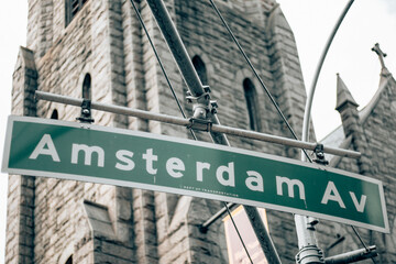Amsterdam Av sign on the side of the street in Manhattan - New York City.