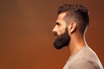 brown Side profile of a young European man with a well-groomed beard, brown monochrome background, grooming concept

Concept: male grooming, style, fashion, beard care, European masculinity