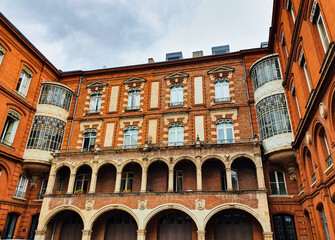 low angle view of a Facade of red bricks building in the city of Toulouse, France