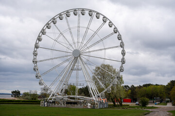 Ferris wheel against a cloudy sky. Ferris wheel close-up.