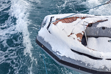 Lifeboat in snow above ocean cold water