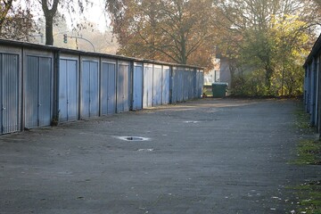 View of a path with many old garages next to each other with metal doors