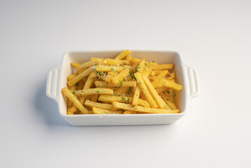 A bowl of crispy French fries decorated with parmesan cheese