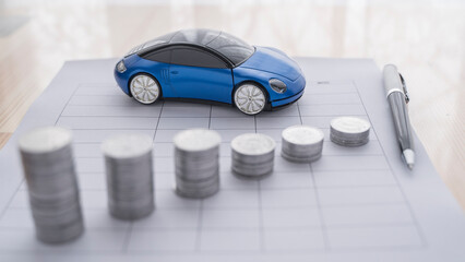 Stacks of coins on the table representing a falling or devaluing graph. Car price . Miniature car...