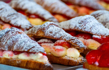 French cuisine, fresh baked strawberry croissants with cream and fresh fruits