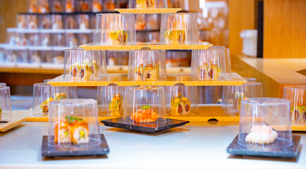 Japanese cuisine, modern restaurant with sushi, sashimi, other Japanese dishes served on moving belt across restaurant, self-service lunch cafe