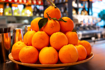Fresh ripe sicilian oranges citrus fruits on board in cocktail bar in Milan, Italy