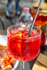 Spritz Campari red bitter long drink cocktail maid with liqueur, prosecco sparkling wine, ice cubes...