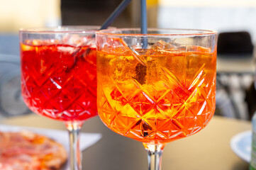 Aperol and Campari Spritz orange bitter long drink cocktails made with liqueur, prosecco sparkling...