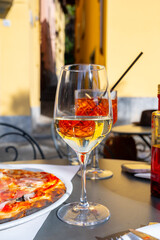 Glass of cold dry white wine served outdoor in cafe in Bellagio, Como lake, Italy
