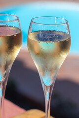 Pouring a glass of champagne on vacation, south of Fuerteventura, Canary islands, blue ocean, mountains