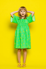 Oh my God, Wow. Preteen child girl kid looking surprised at camera with big eyes, shocked by game victory winning lottery goal achievemen good news. Children isolated on yellow background. Vertical