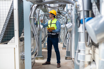 An engineer checks the status of a large AHU air conditioner control valve.