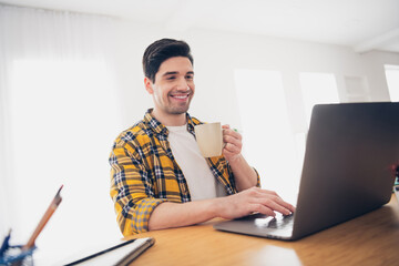 Photo of cheerful positive guy dressed plaid shirt texting apple samsung modern gadget enjoying...