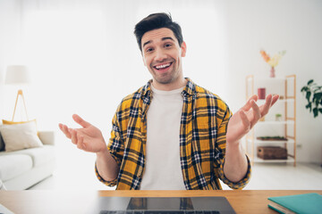 Photo of excited positive guy dressed plaid shirt video call modern gadget indoors room home house