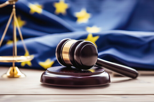 photograph showcasing the intricate details of a judge's wooden gavel, with the EU flag prominently displayed in the background, representing the harmonization of legal principles