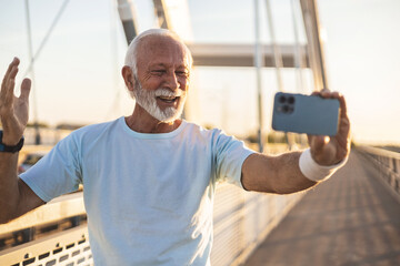 A senior man taking a fun selfie during his workout. Elderly man runner, training selfie and smile...