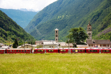 Swiss red train in mountain landscape, scenic ride - 794059024
