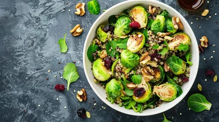Rolgordijnen Fried brussels sprouts salad with quinoa, cranberries and nuts in a white bowl. © Vasiliy