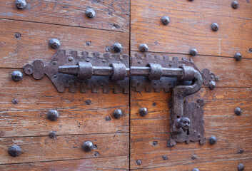 Antique door latch in the Italian countryside.