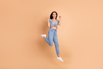 Photo of adorable cheerful lucky woman wear blue trendy clothes scream hooray isolated on beige...