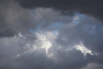 Fototapeta na wymiar Grey storm clouds on a blue sky