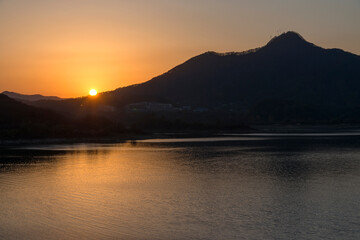View of the sunset over the mountain at the lakeside
