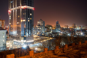 Panorama of the night city. View of the buildings in the evening twilight. Modern residential city...