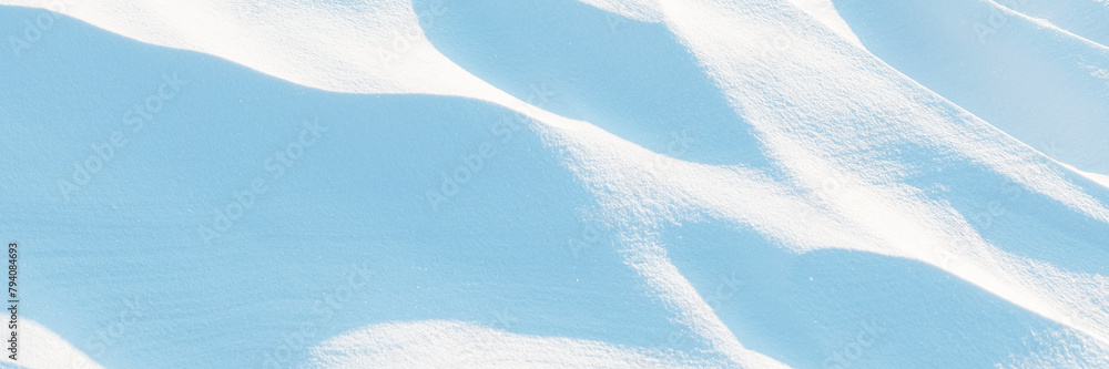 Wall mural snow texture. wind sculpted patterns on snow surface. wind in the tundra and in the mountains on the