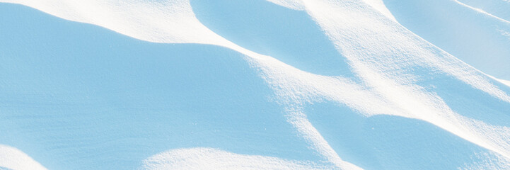 Snow texture. Wind sculpted patterns on snow surface. Wind in the tundra and in the mountains on the surface of the snow sculpts patterns and ridges (sastrugi). Arctic, Polar region. Winter background - 794084693