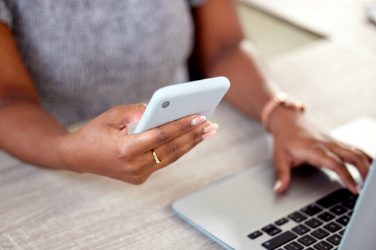 Hands, business and woman with laptop, cellphone and typing with connection, internet and hotspot for internet. Person, closeup or consultant at desk, computer and smartphone with social media or app
