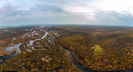 Aerial autumn river dale panorama with colorful autumnal woodland in Ukraine countryside